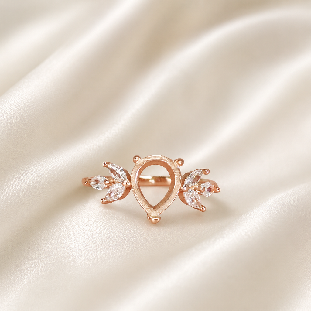 Rose gold 925 sterling silver wing teardrop ring setting with marquise CZ leaf accents on cream satin - front view