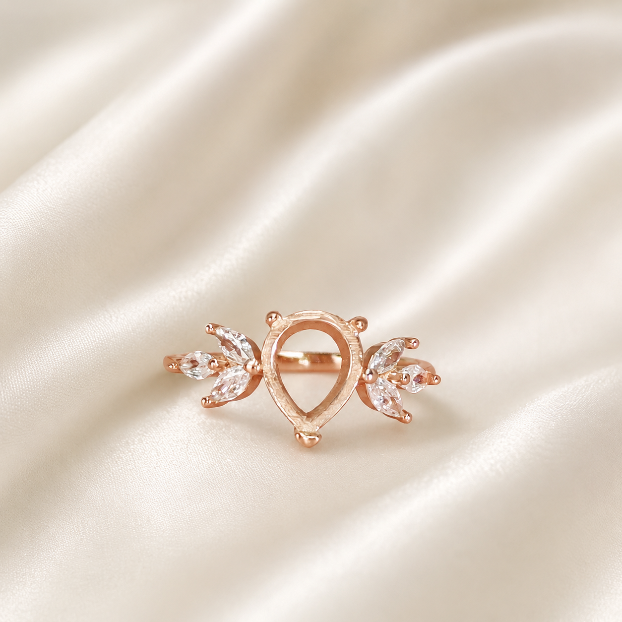 Rose gold 925 sterling silver wing teardrop ring setting with marquise CZ leaf accents on cream satin - front view