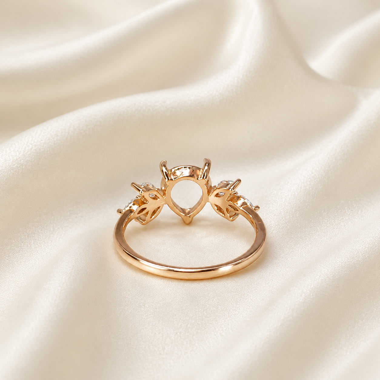 Gold 925 sterling silver wing teardrop ring setting showing open back pear bezel on cream satin