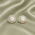 Rose gold sunflower halo earrings with white resin keepsake inclusion on sage green satin