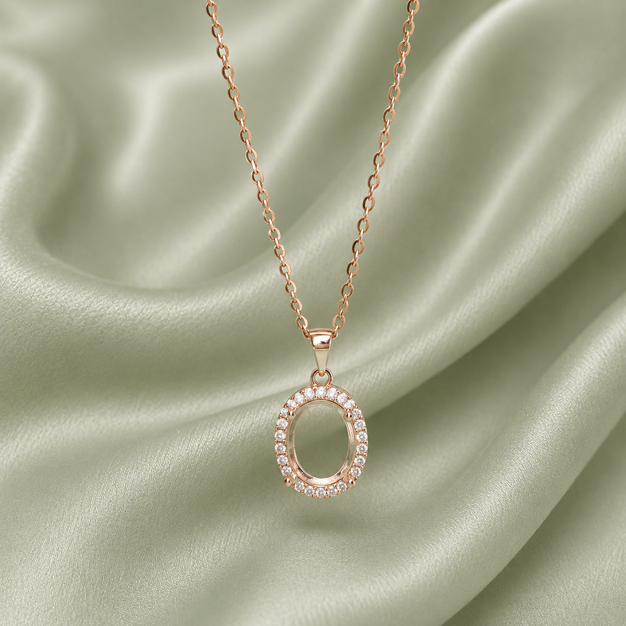 Rose gold 925 sterling silver halo oval necklace setting with CZ surround on sage green satin