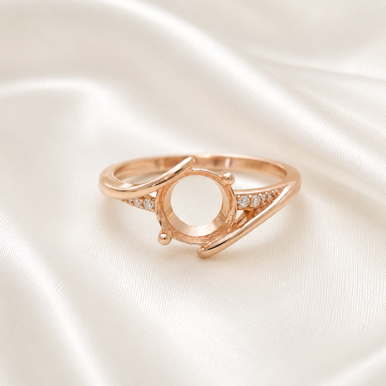 Rose gold 925 sterling silver round open bezel split shank ring setting with CZ accents on cream satin - front view