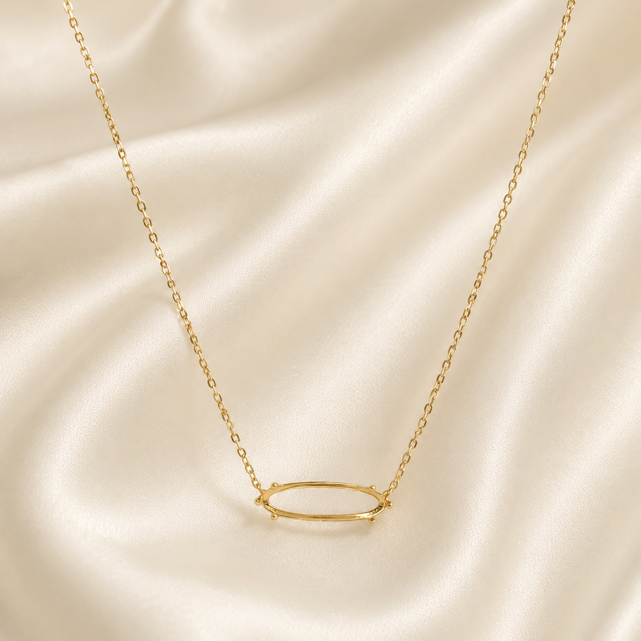 Gold 925 sterling silver vertical oval necklace setting on cream satin showing open bezel center