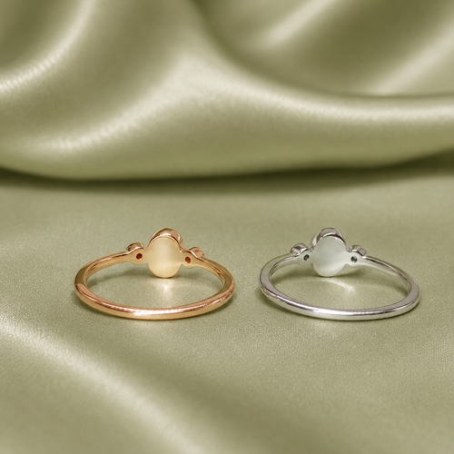 Back view of rose gold and silver oval blank ring settings on sage green satin