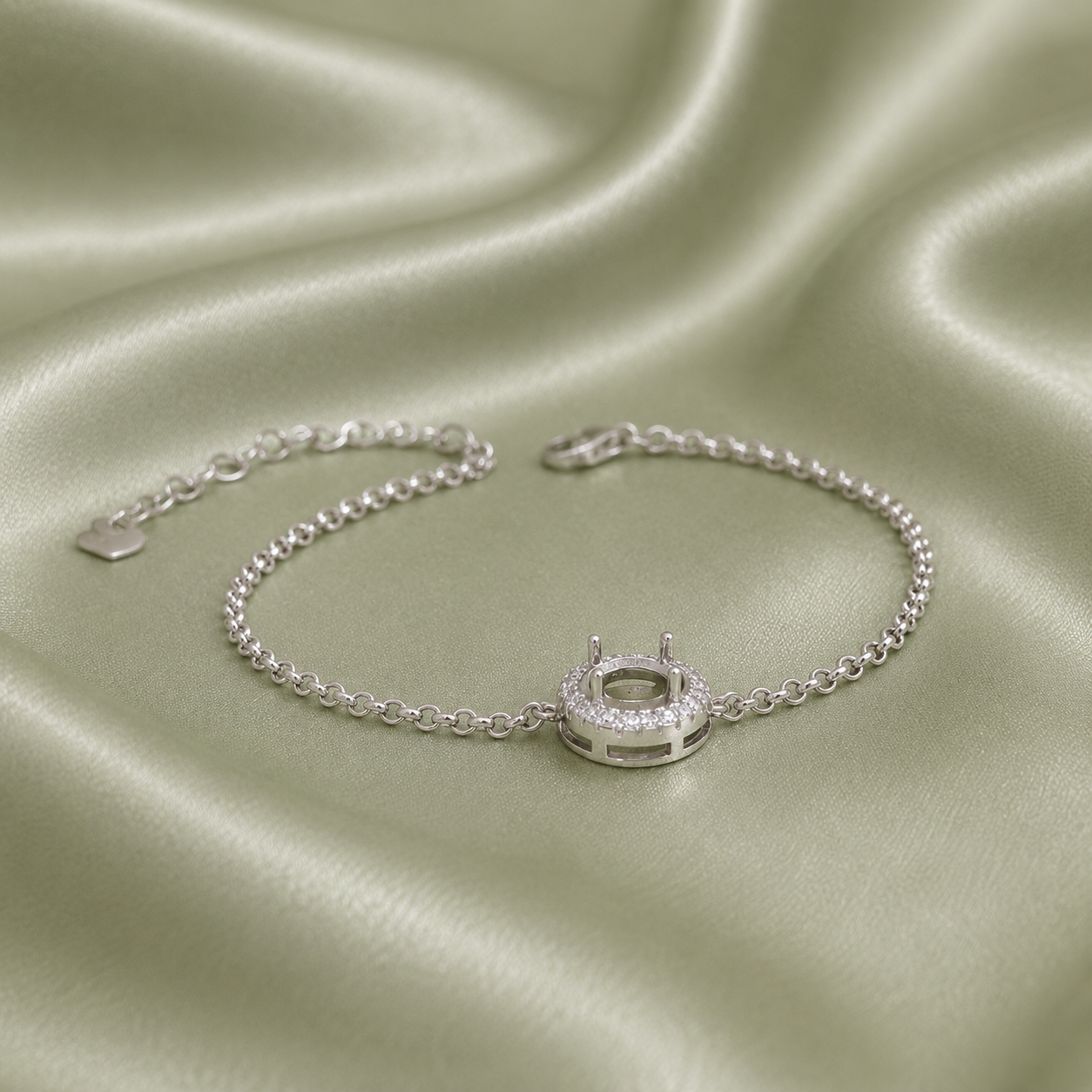 925 sterling silver halo round blank bracelet setting with CZ surround on sage green satin fabric