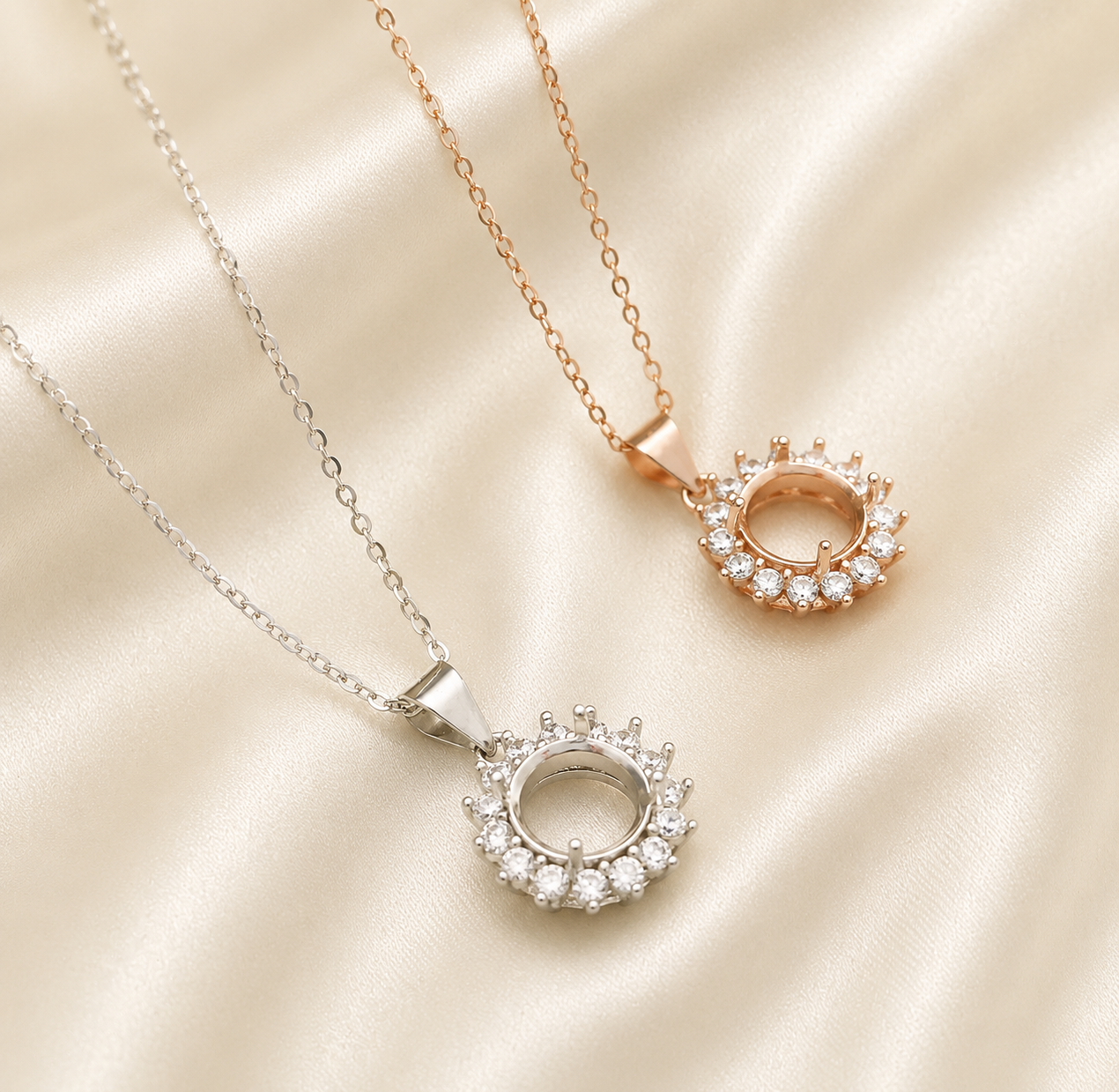Silver and rose gold halo round blank necklace settings on cream satin showing open center bezel detail - angled view