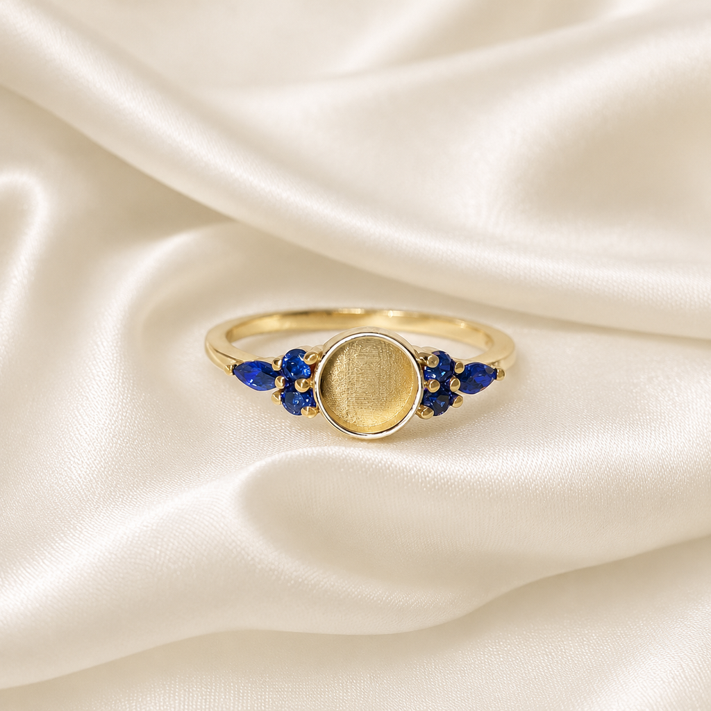 Gold 925 sterling silver round ring setting with blue sapphire pear-cut birthstone cluster accents on white satin