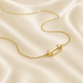 Gold 925 sterling silver horizontal oval necklace setting with prong detail on cream satin