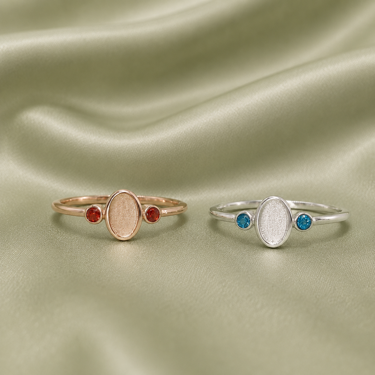 Front view of rose gold and silver oval blank rings with red and blue birthstone accents