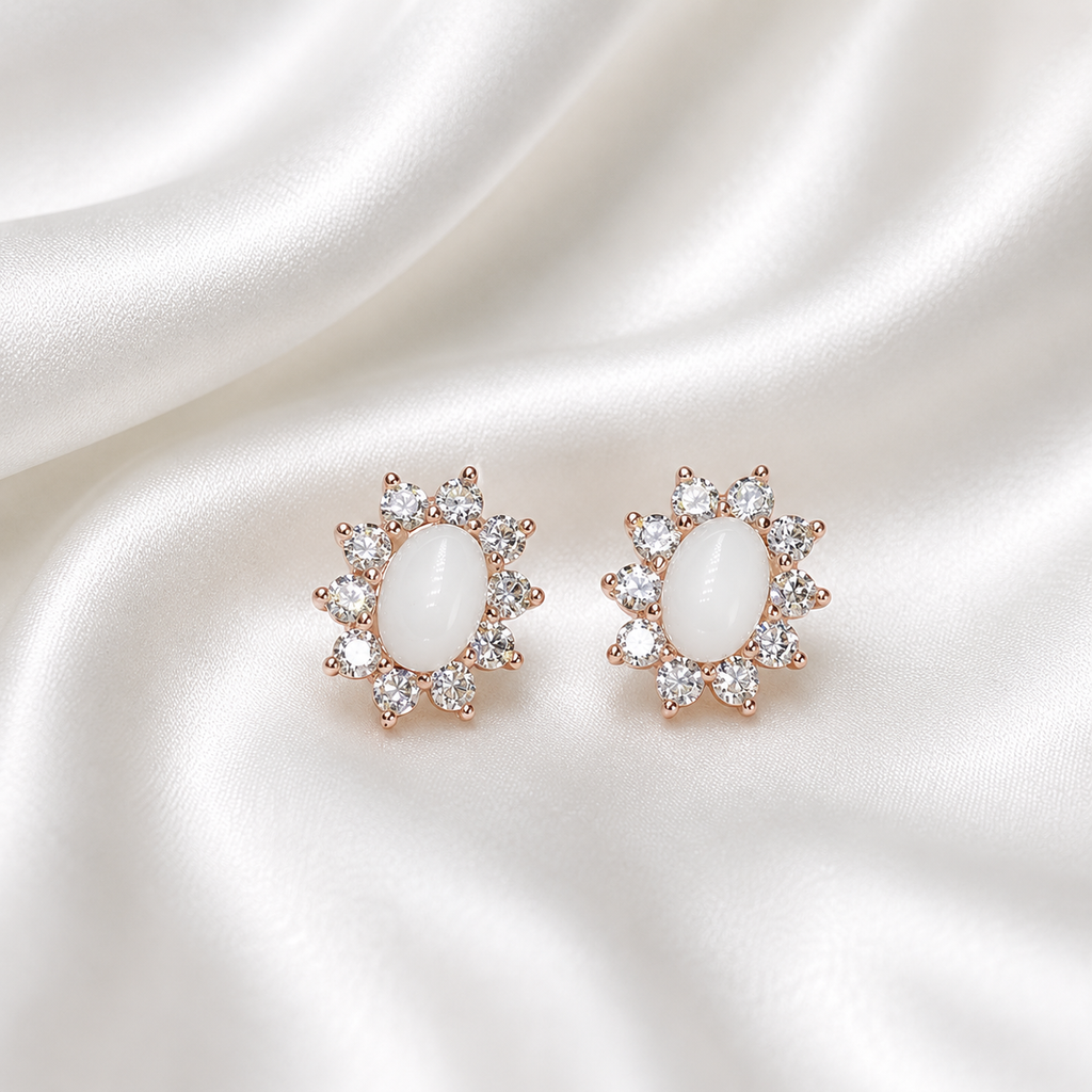 Rose gold starburst halo oval earring settings filled with white milk resin on white satin