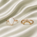 Rose gold teardrop milk resin ring set with yellow bezel-set birthstone stacker band on sage satin