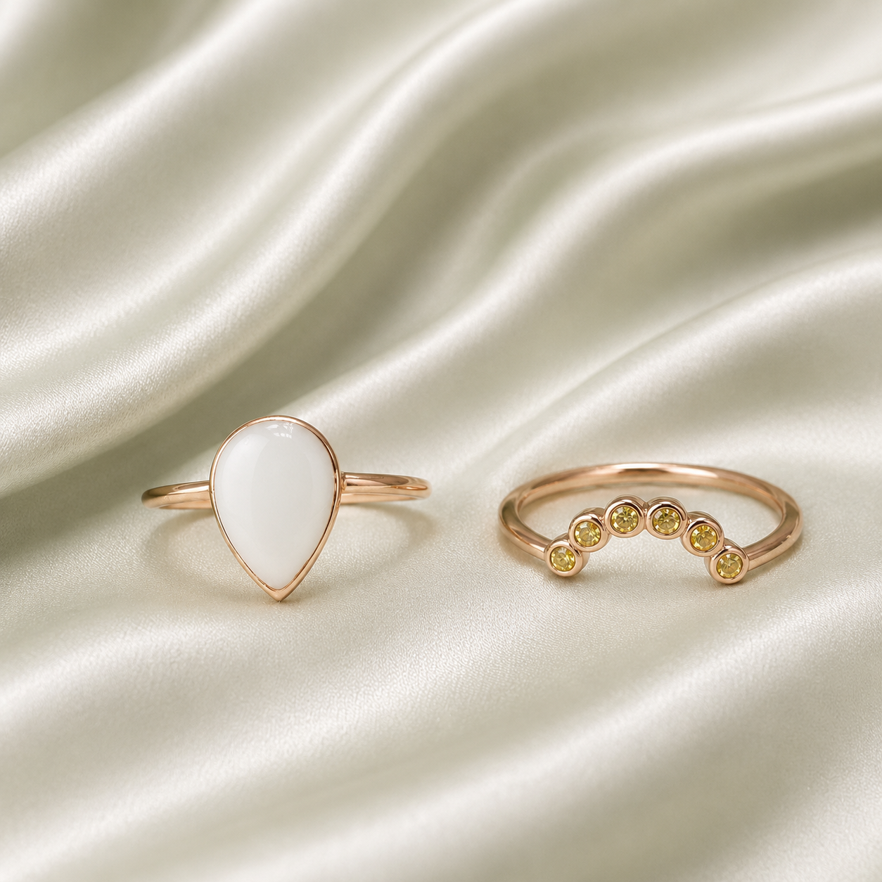 Rose gold teardrop milk resin ring set with yellow bezel-set birthstone stacker band on sage satin