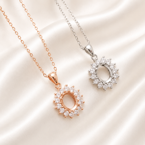Rose gold and silver halo oval blank necklace settings with CZ sunburst surround on cream satin