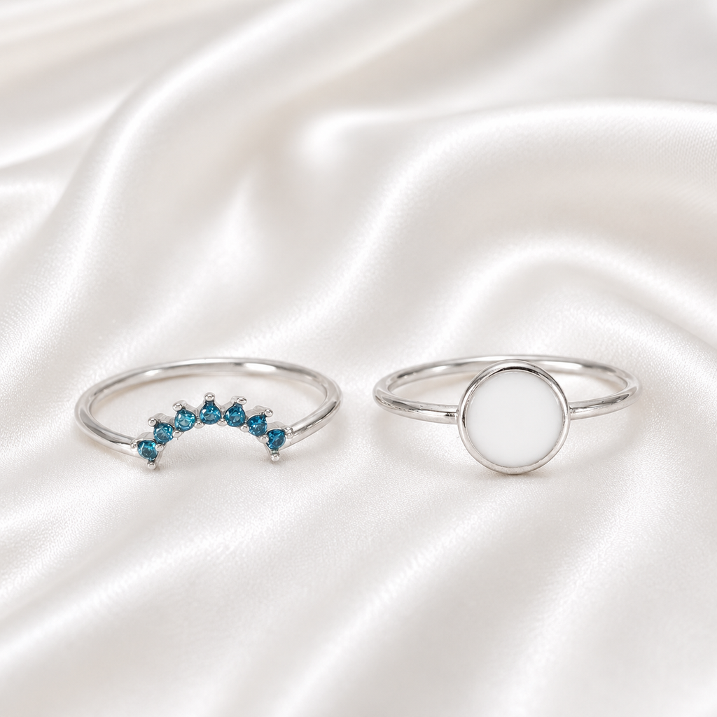 925 Sterling Silver Round Bezel Ring Set with teal birthstone stacker band on white satin