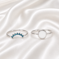 925 Sterling Silver Round Bezel Ring Set with teal birthstone stacker band on white satin