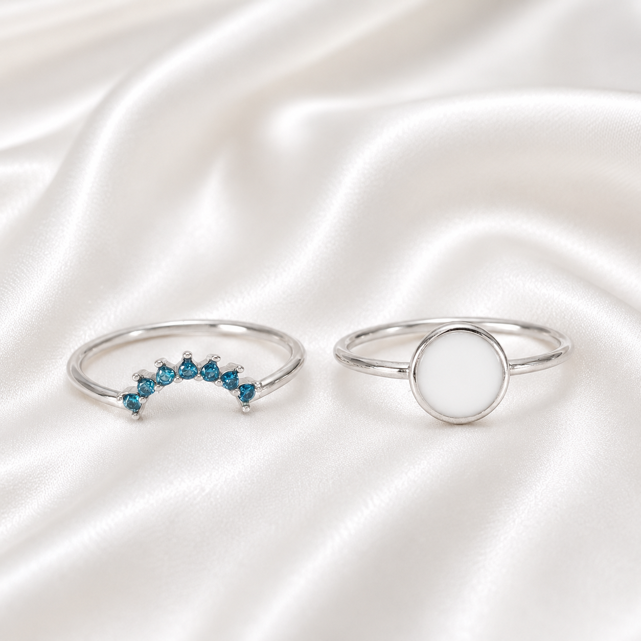 925 Sterling Silver Round Bezel Ring Set with teal birthstone stacker band on white satin