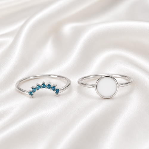 925 Sterling Silver Round Bezel Ring Set with teal birthstone stacker band on white satin