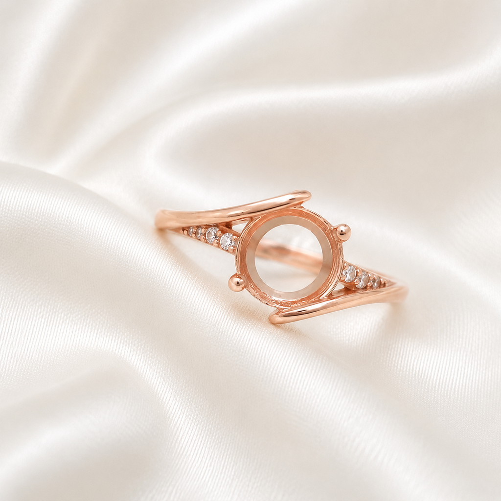 Rose gold 925 sterling silver round open bezel split shank ring setting with CZ accents on cream satin - angle view