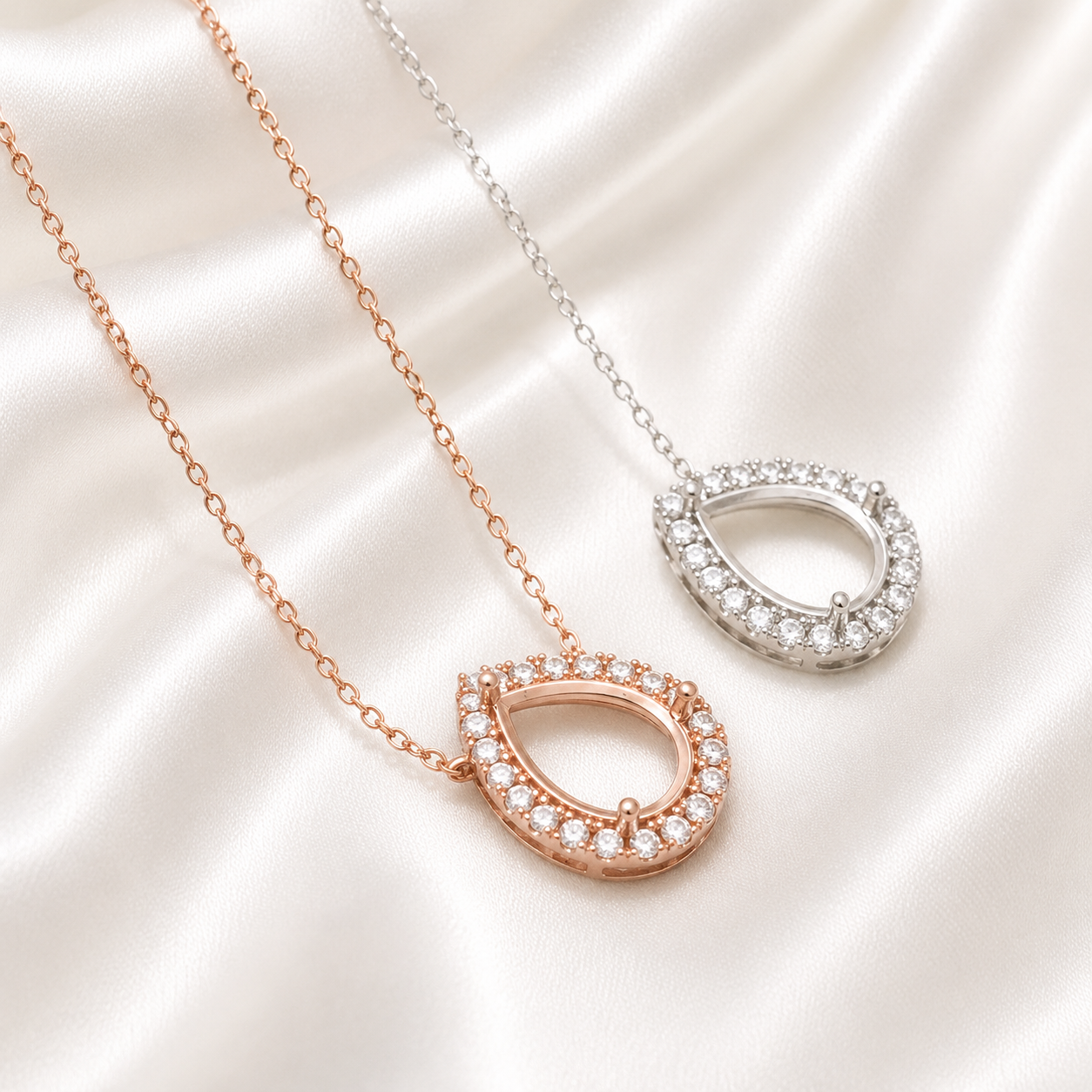 Rose gold and silver halo teardrop necklace settings with CZ stones on satin
